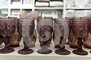 Beautiful wine glasses in the store. Cozy home decor. Close-up