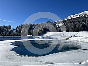 Beautiful winter atmosphere on storage lake Valos or reservoir lake Valos (Speichersee Valos)