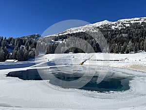 Beautiful winter atmosphere on storage lake Valos or reservoir lake Valos (Speichersee Valos)