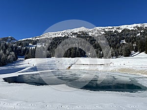 Beautiful winter atmosphere on storage lake Valos or reservoir lake Valos (Speichersee Valos)