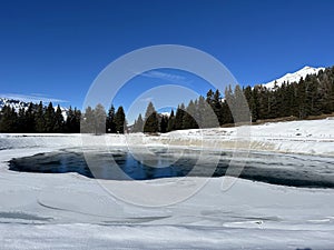 Beautiful winter atmosphere on storage lake Valos or reservoir lake Valos (Speichersee Valos)