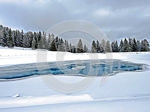 Beautiful winter atmosphere on storage lake Valos or reservoir lake Valos (Speichersee Valos) above the Lenzerheide