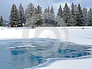 Beautiful winter atmosphere on storage lake Valos or reservoir lake Valos (Speichersee Valos) above the Lenzerheide