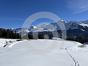 Beautiful winter atmosphere on storage lake Valos or reservoir lake Valos (Speichersee Valos) above the tourist resorts