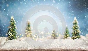 Beautiful winter background with wooden old desk, fir trees and blurred blue sky. Winter, New Year and Christmas concept with