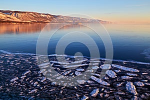 Beautiful winter landscape. Frozen Lake Baikal in the morning. Huge expanses of transparent ice.