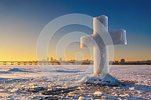 Beautiful winter landscape with Ice Cross on frozen river and sunset sky