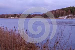 Beautiful winter landscape with lake in Trakai, Lithuania in evening time