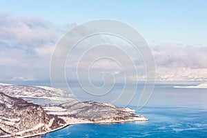 Beautiful winter landscape with mountains and fjord