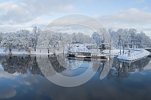 Beautiful winter landscape with nice reflection in water of river