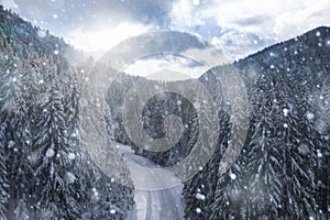 Beautiful winter landscape. Snow covered mountain road snowfall view aerial
