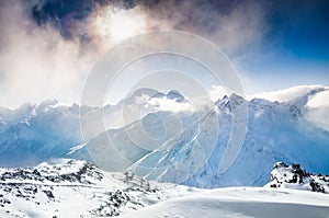 Beautiful winter landscape with snow-covered mountains at sunset