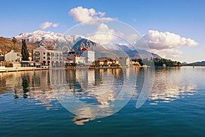 Beautiful winter Mediterranean landscape and its reflection in water . Montenegro, embankment of Tivat city