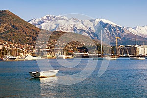 Beautiful winter Mediterranean landscape. Montenegro, Bay of Kotor. View of snow-capped mountain of Lovcen and town of Tivat