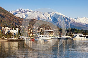 Beautiful winter Mediterranean landscape. Montenegro, Bay of Kotor. View of snow-capped peaks of Lovcen mountain and Tivat city