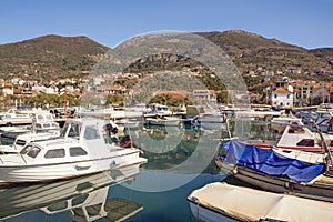 Beautiful winter Mediterranean landscape with small harbor for fishing boats.  Montenegro. View of Marina Kalimanj in Tivat city