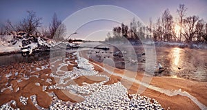 A Beautiful Winter Morning Landscape: The Sun Rising Over The Forest And The Sandy Shallows Of The River, Covered With Frost Cryst photo