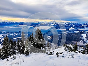 Beautiful winter mountain landscape in Tyrol. Gray clouds, a small glimmer of light