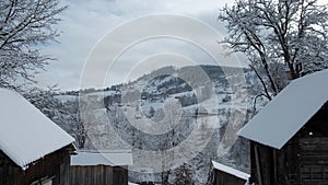 Beautiful winter in a mountain village. A view of the houses among the mountains in winter