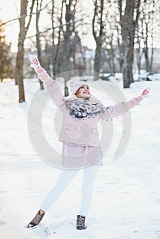 Beautiful winter portrait of young woman in the winter snowy scenery