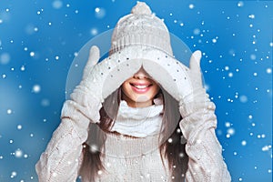 Beautiful winter portrait of young woman in the winter snowy scenery . Snowing winter beauty concept. Girl closes eyes with her ha