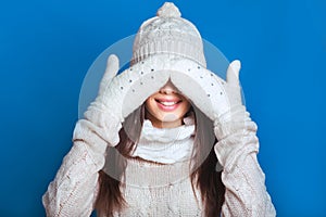 Beautiful winter portrait of young woman in the winter snowy scenery . Snowing winter beauty concept. Girl closes eyes with her ha