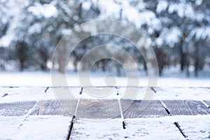 Beautiful winter scene. blurred background of snowy christmas nature background, Wood table top on shiny bokeh. For product