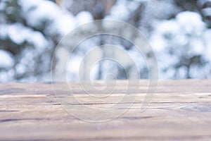 Beautiful winter scene. blurred background of snowy christmas nature background, Wood table top on shiny bokeh. For product