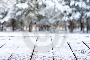 Beautiful winter scene. blurred background of snowy christmas nature background, Wood table top on shiny bokeh. For product