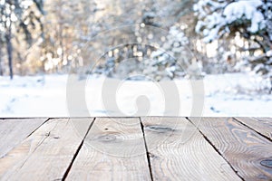 Beautiful winter scene. blurred background of snowy christmas nature background, Wood table top on shiny bokeh. For