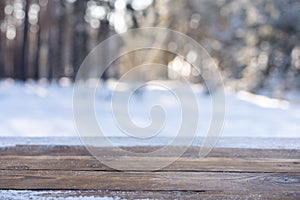 Beautiful winter scene. blurred background of snowy christmas nature background, Wood table top on shiny bokeh. For product