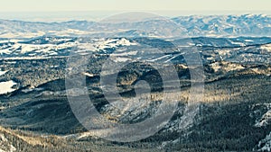 Beautiful winter scenery of mountain with pine forest covered in snow. Panning shot