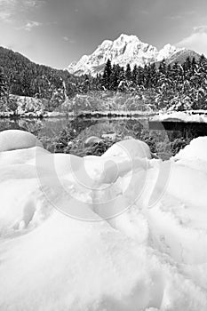 Beautiful winter scenery on pure lake Zelenci in cold sunrise in black and white, Kranjska Gora, Slovenia