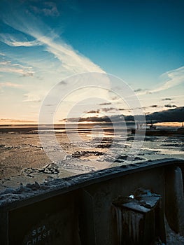 Beautiful winter seascape from cargo ship. Sunrise at cargo port.