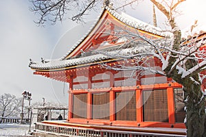 Beautiful winter seasonal of Red Pagoda at Kiyomizu-dera temple surrounded with trees covered white snow background at Kyoto.