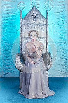 Beautiful winter snow queen on throne