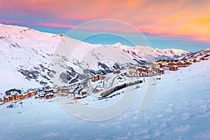 Beautiful winter sunrise landscape, famous ski resort with typical alpine wooden houses in French Alps, Les Menuires, 3 Vallees,
