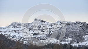 Beautiful Winter sunrise landscape image of Mount Snowdon and ot