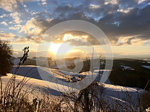 Beautiful winter sunset with fresh snow - view over the remote emmental. Canton Bern, Switzerland
