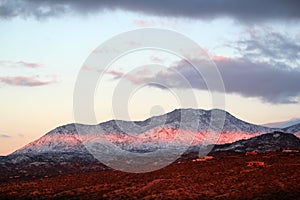 Beautiful winter sunset with snow covered Santa Catalina Pusch Ridge mountains in Tucson, Arizona