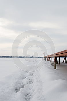 Beautiful winter sunset in a snowy park by the lake