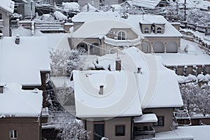 Beautiful winter view of houses and buildings with roofs covered with heavy snow. In snowy season, roof with lot snow.