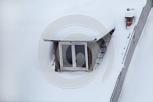 Beautiful winter view of houses and buildings with roofs covered with heavy snow. In snowy season, roof with lot snow.