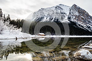 Beautiful winter view of a wooden cabin at Lake Louise, Canada