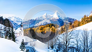 Beautiful winter wonderland mountain scenery in the Alps with pilgrimage church of Maria Gern and famous Watzmann summit in the