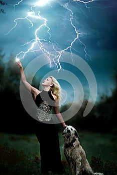 Beautiful witch girl controls lightning strike