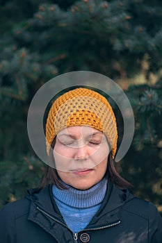 Beautiful woman in 40s headshot portrait in park