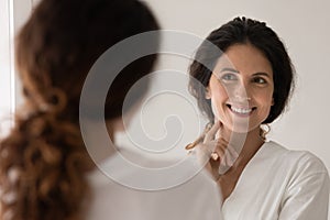 Beautiful woman admire face view looking in mirror