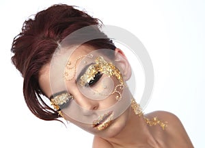 Beautiful Woman Adorned with Gold Leaf Cosmetics