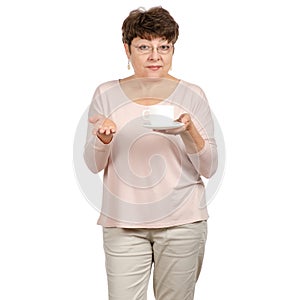 Beautiful woman aged with glasses in hand a cup and saucer tea coffee